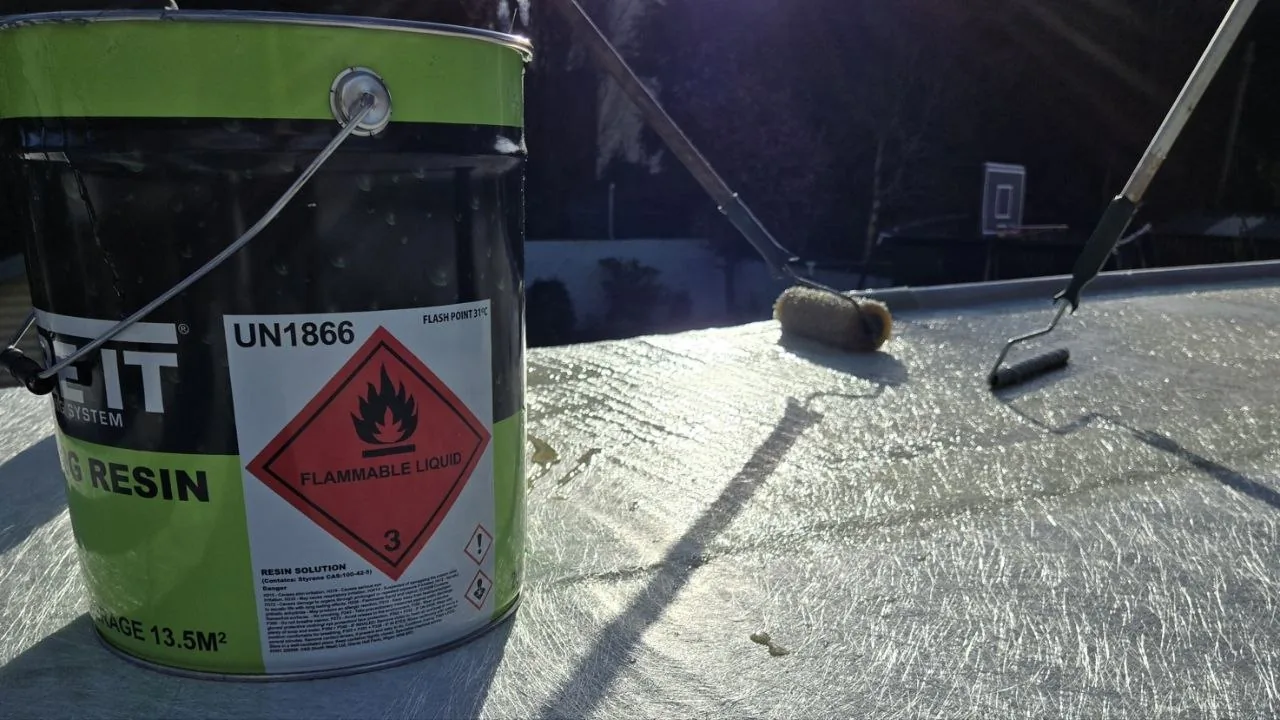 Fibreglass resin and rollers on a flat roof