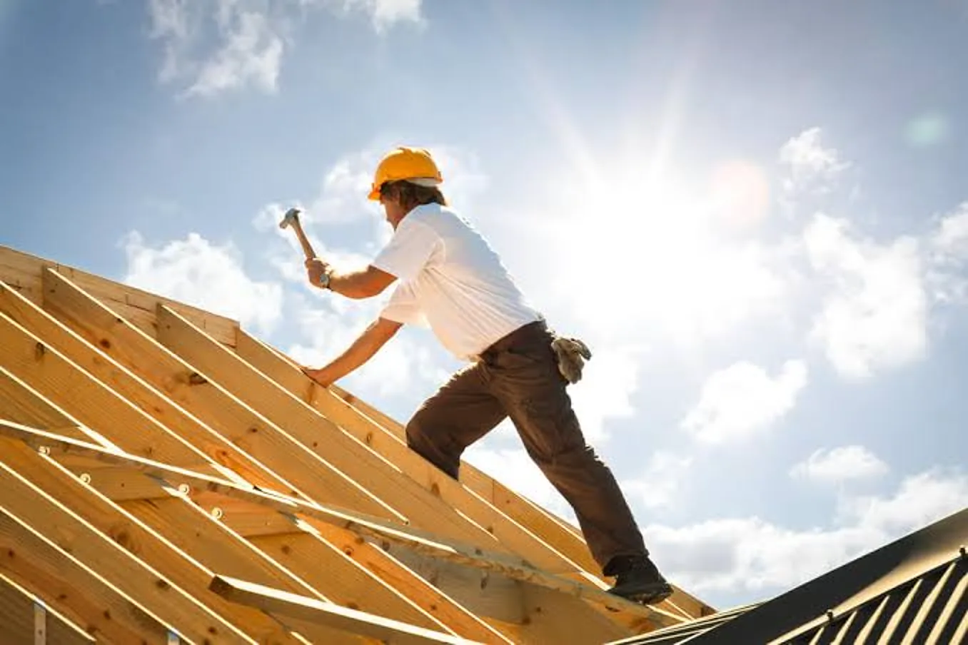 Roofer fitting slates on a pitched roof