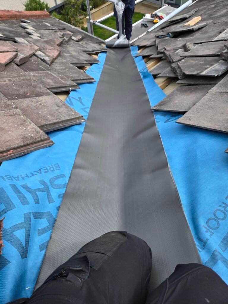 Flexible lead-alternative valley liner installed over breathable roofing underlay