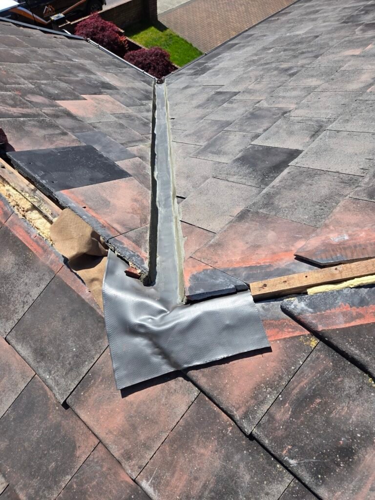 Lead-alternative flashing dressed into a valley during a tile roof repair