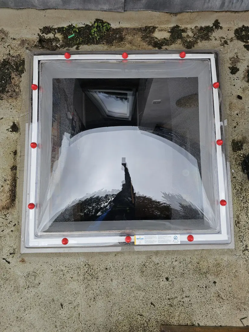 Finished skylight replacement on a flat roof with a clear Skylux double-skin dome
