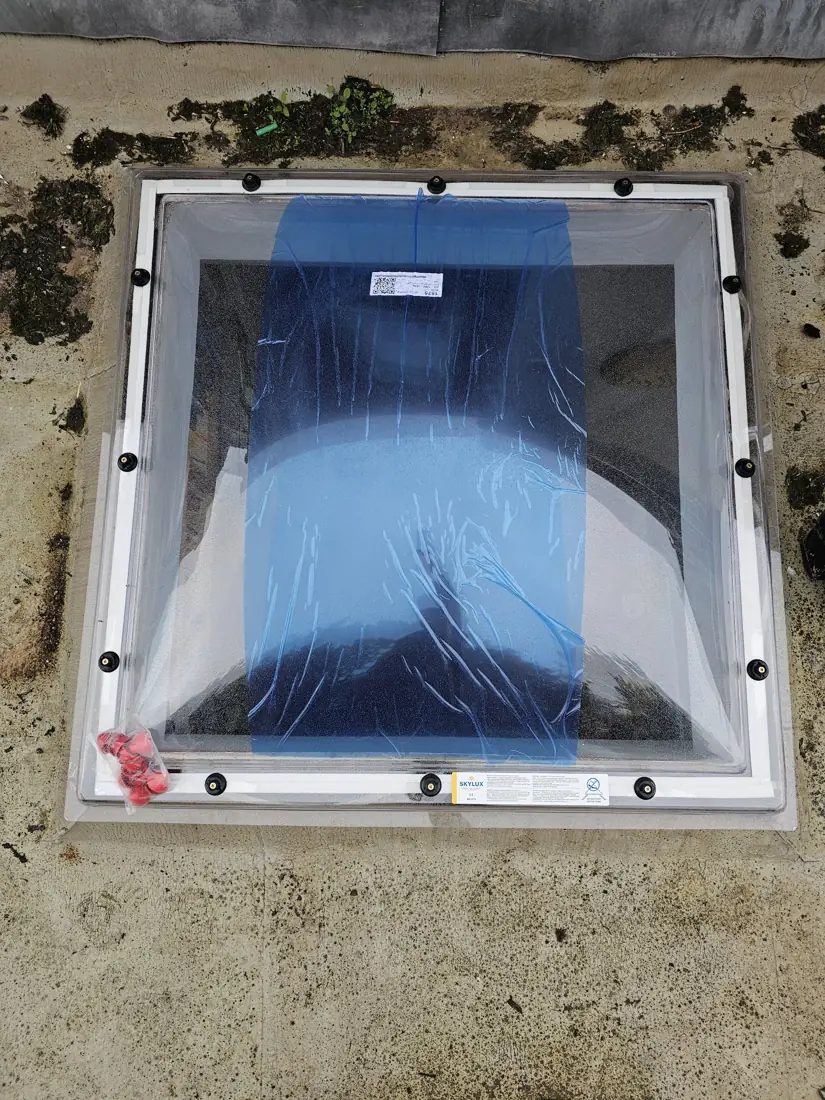 New Skylux double-skin skylight dome fixed to the existing upstand, protective film still on