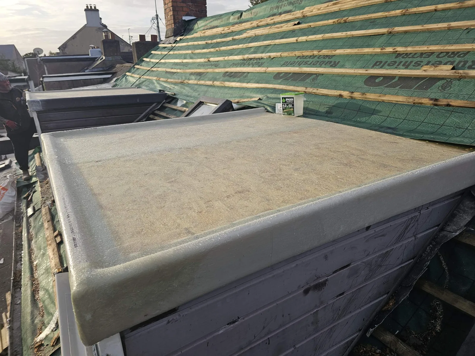 New GRP fibreglass dormer roof with formed edge trims, main roof being re-battened behind