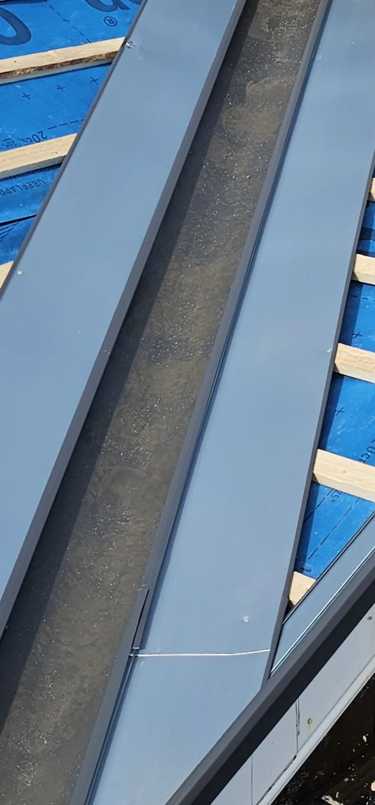 Dry metal valley trough fitted over battens and breathable membrane on a new roof