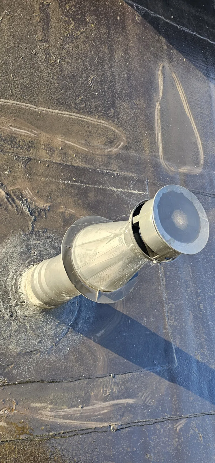 Soil vent pipe with weather collar through a torch-on felt flat roof